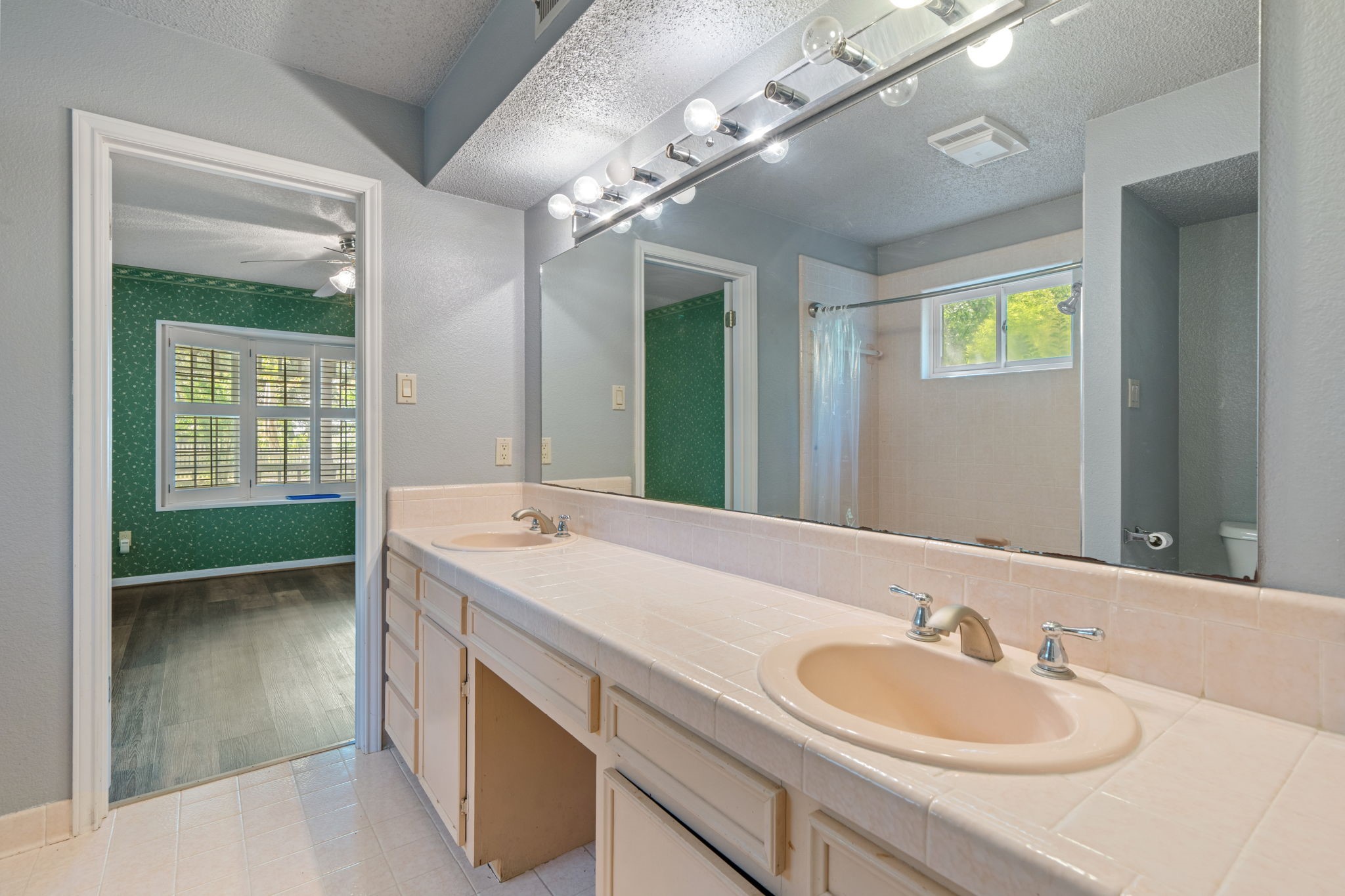 3541 Highway 159 La Grange, TX 78945 - Photo 19 of 38 Secondary bathroom with vanity, dual sinks, a large mirror, and a shower/tub combo.
