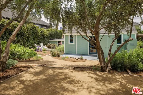 a view of backyard of house with green space