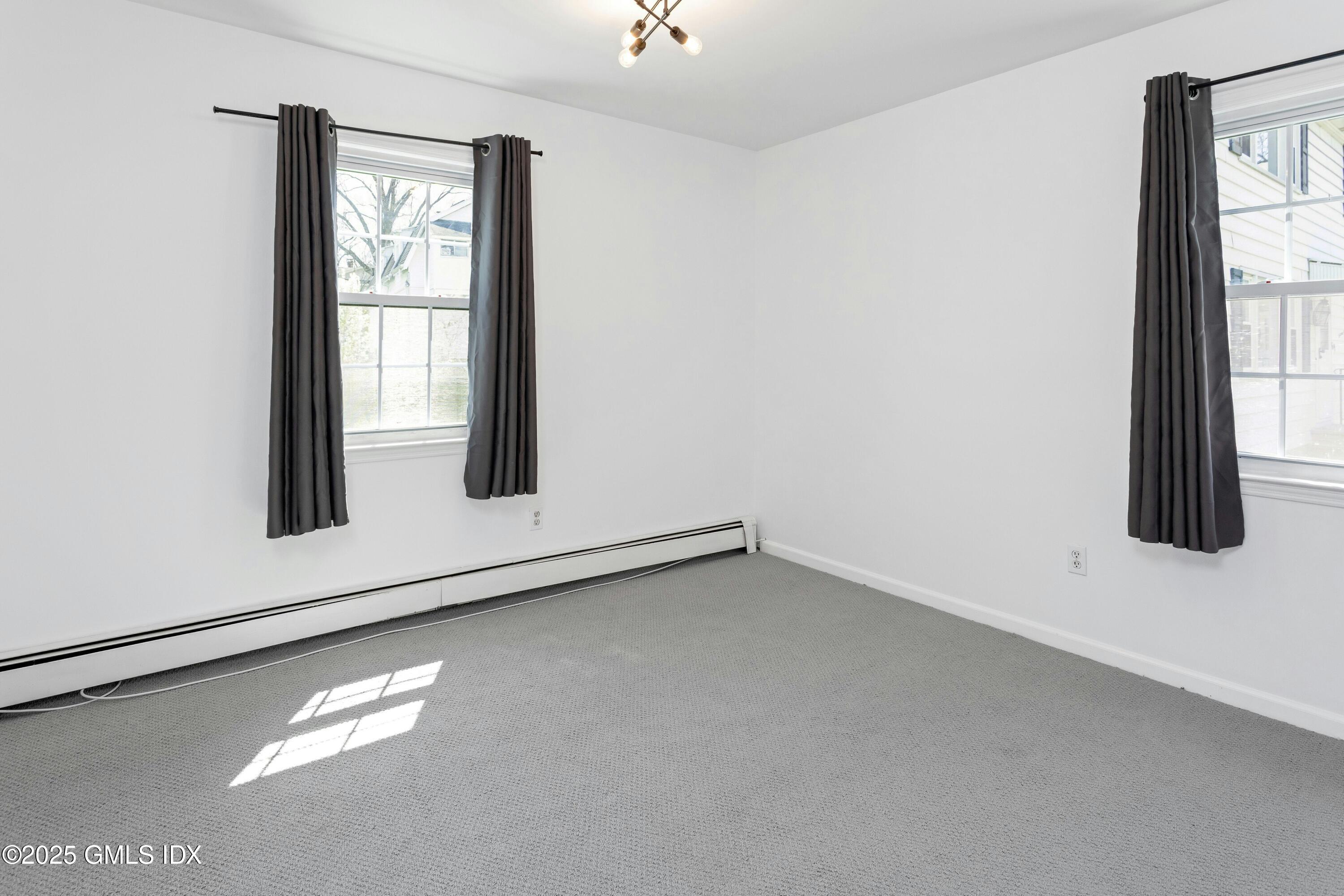 171 1/2 Henry Street, Unit A Greenwich, CT 06830 - Photo 11 of 25 an empty room with windows