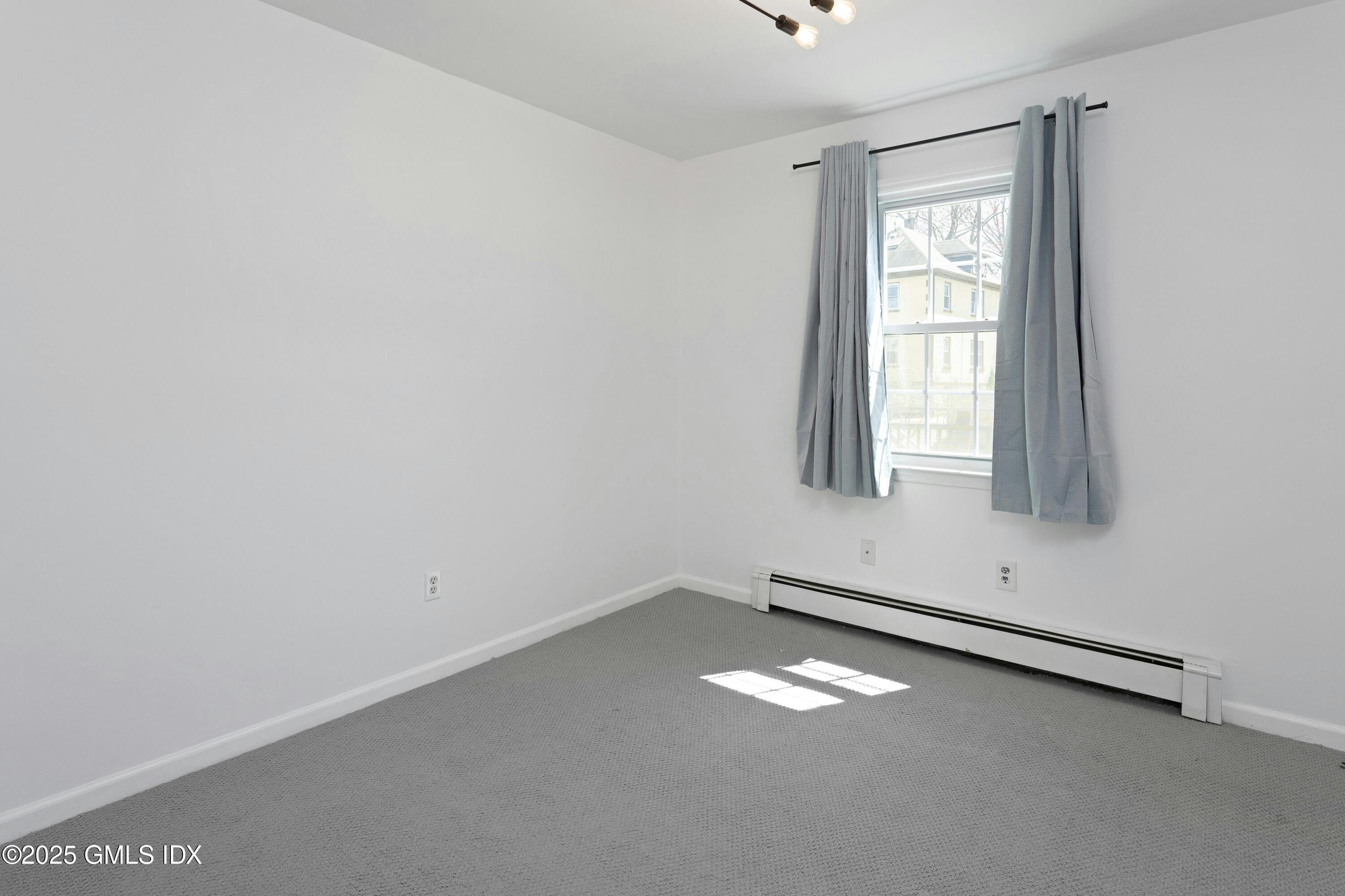 171 1/2 Henry Street, Unit A Greenwich, CT 06830 - Photo 12 of 25 an empty room with a window