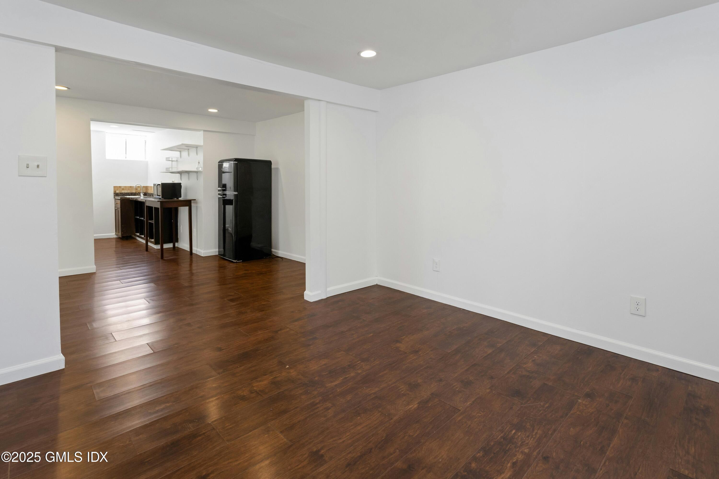 171 1/2 Henry Street, Unit A Greenwich, CT 06830 - Photo 18 of 25 a view of an empty room with wooden floor