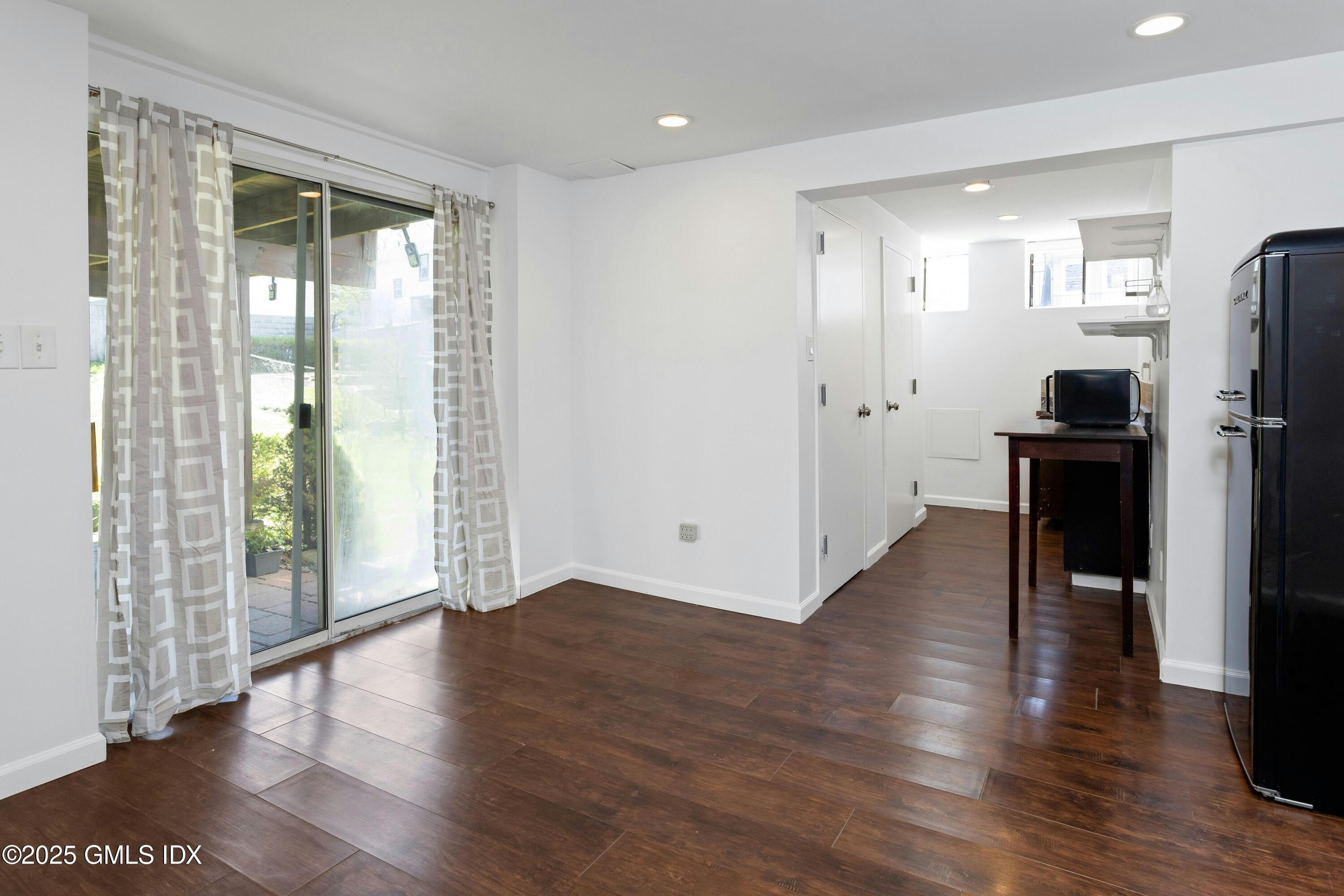 171 1/2 Henry Street, Unit A Greenwich, CT 06830 - Photo 19 of 25 a view of a livingroom with wooden floor and furniture