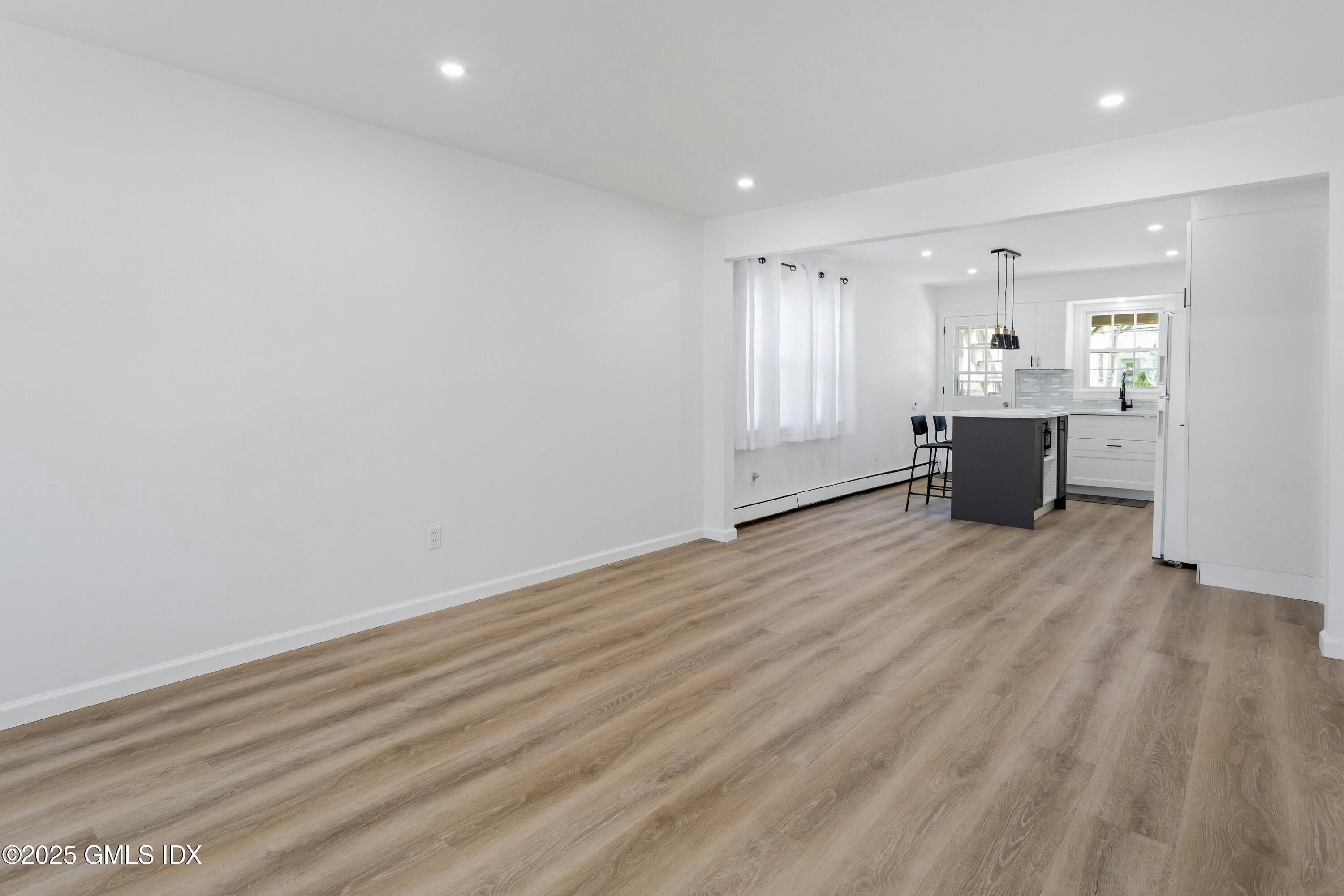 171 1/2 Henry Street, Unit A Greenwich, CT 06830 - Photo 3 of 25 an empty room with wooden floor and windows