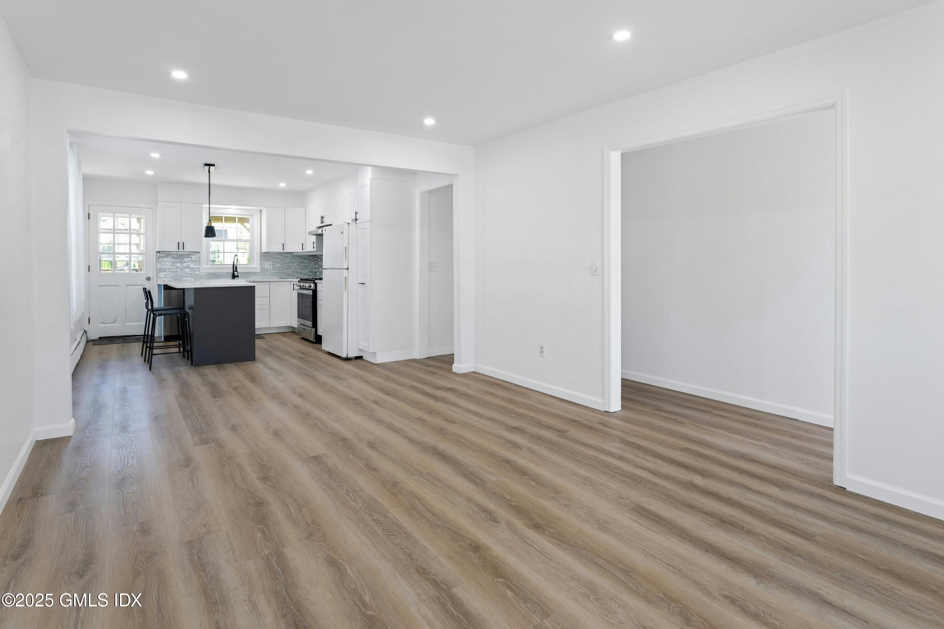 171 1/2 Henry Street, Unit A Greenwich, CT 06830 - Photo 4 of 25 a view of kitchen with wooden floor and electronic appliances