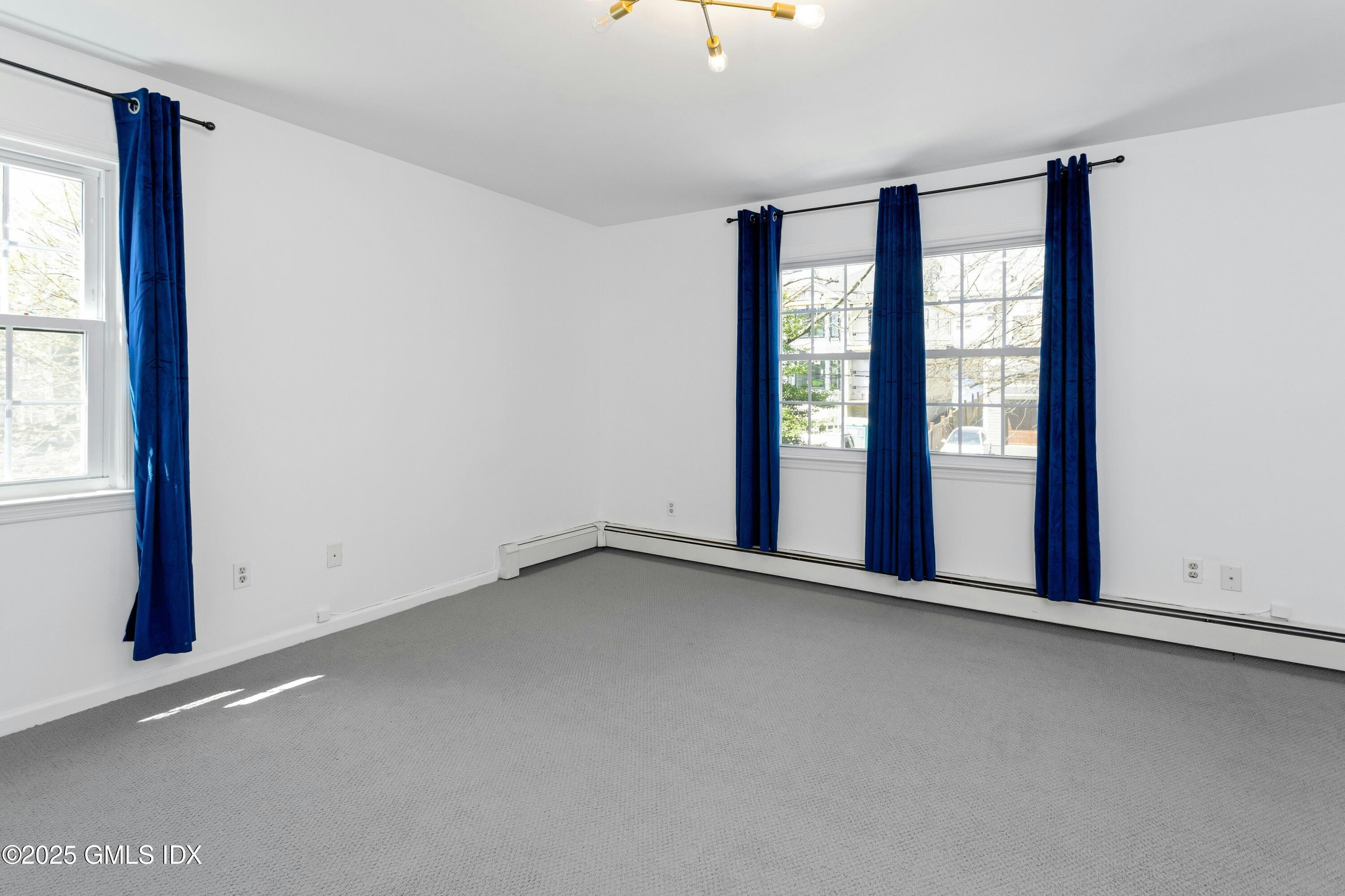 171 1/2 Henry Street, Unit A Greenwich, CT 06830 - Photo 9 of 25 an empty room with windows