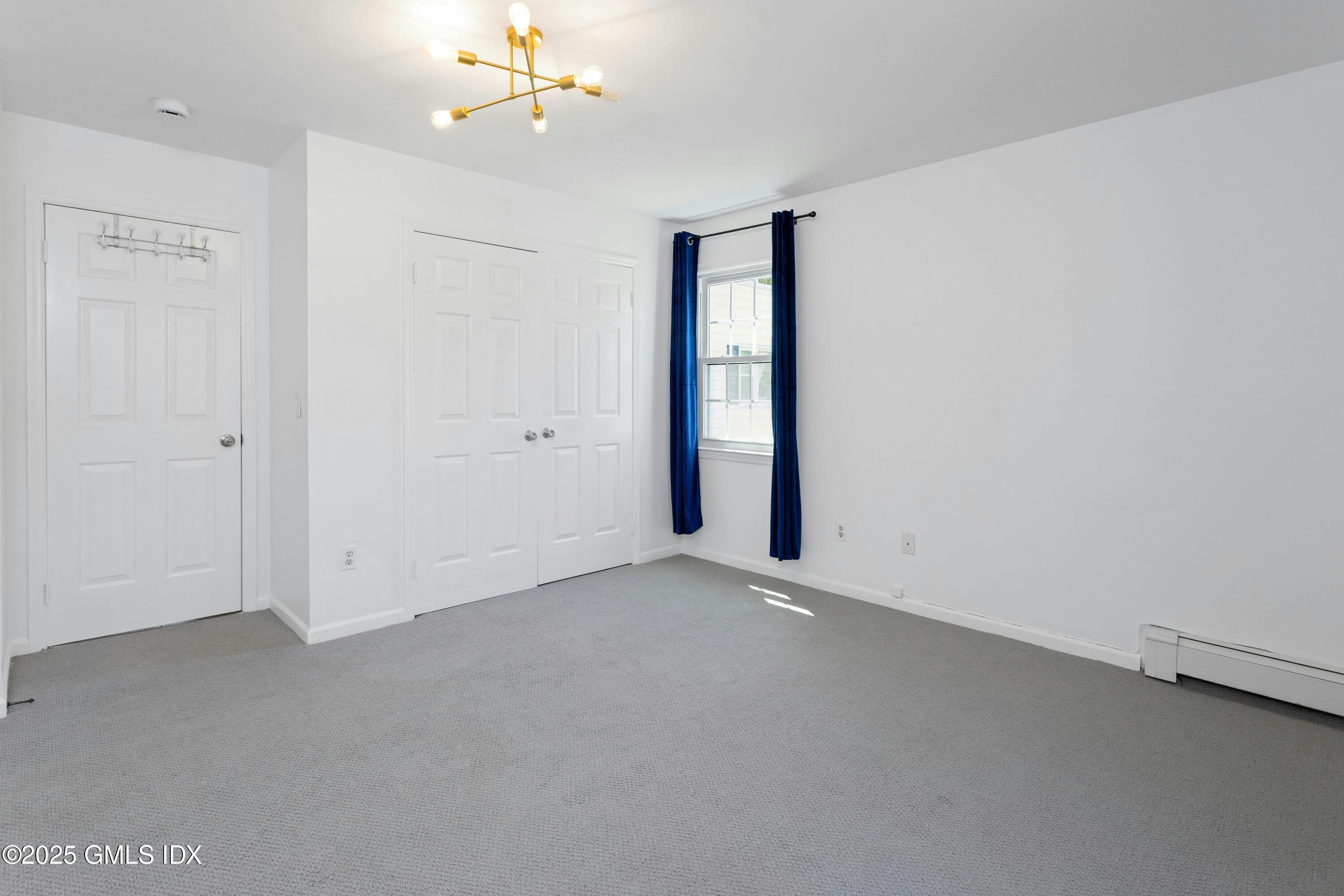 171 1/2 Henry Street, Unit A Greenwich, CT 06830 - Photo 10 of 25 an empty room with a ceiling fan and a window
