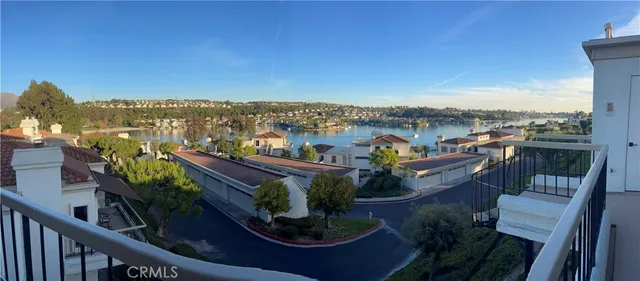 a view of a balcony with two chairs and a potted plant