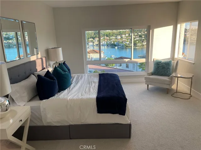 a bedroom with a bed and a large window