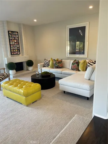 a living room with furniture and kitchen view