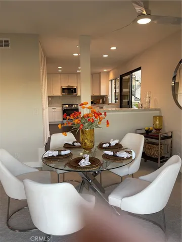 a kitchen with granite countertop white cabinets and stainless steel appliances