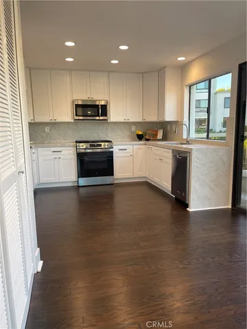 a kitchen with a stove a sink and a refrigerator