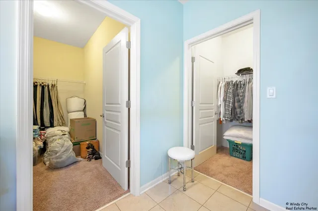 a view of a hallway with bathroom and shower