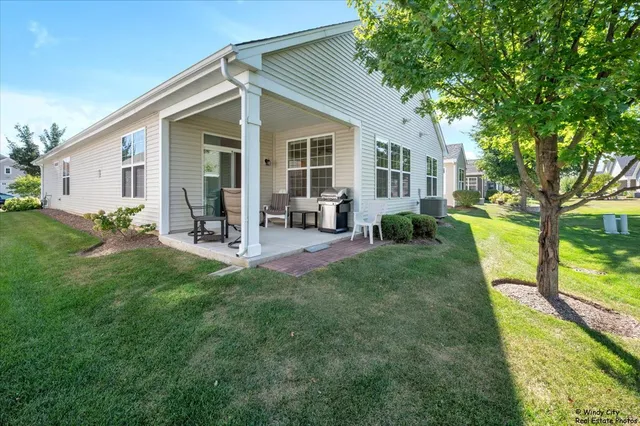 a view of a house with backyard sitting area and garden