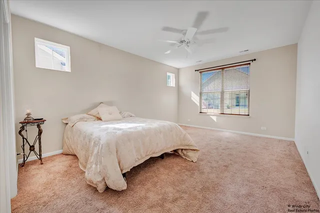 a spacious bedroom with a bed and a table