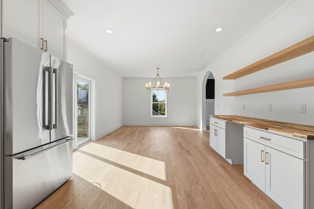 16 Couture Way Middleton, MA 01949 - Photo 13 of 36 a open kitchen with white cabinets and wooden floor