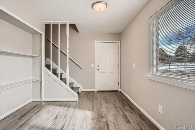 a view of entryway with wooden floor and stairs