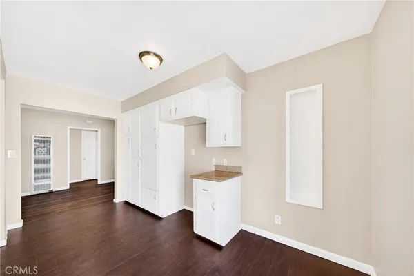 a view of a room with wooden floor and window