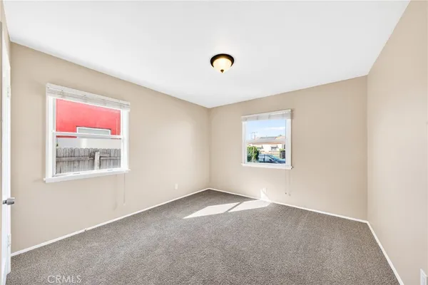 a view of a hallway with wooden floor and closet