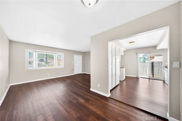 a large kitchen with a lot of counter space and wooden floor