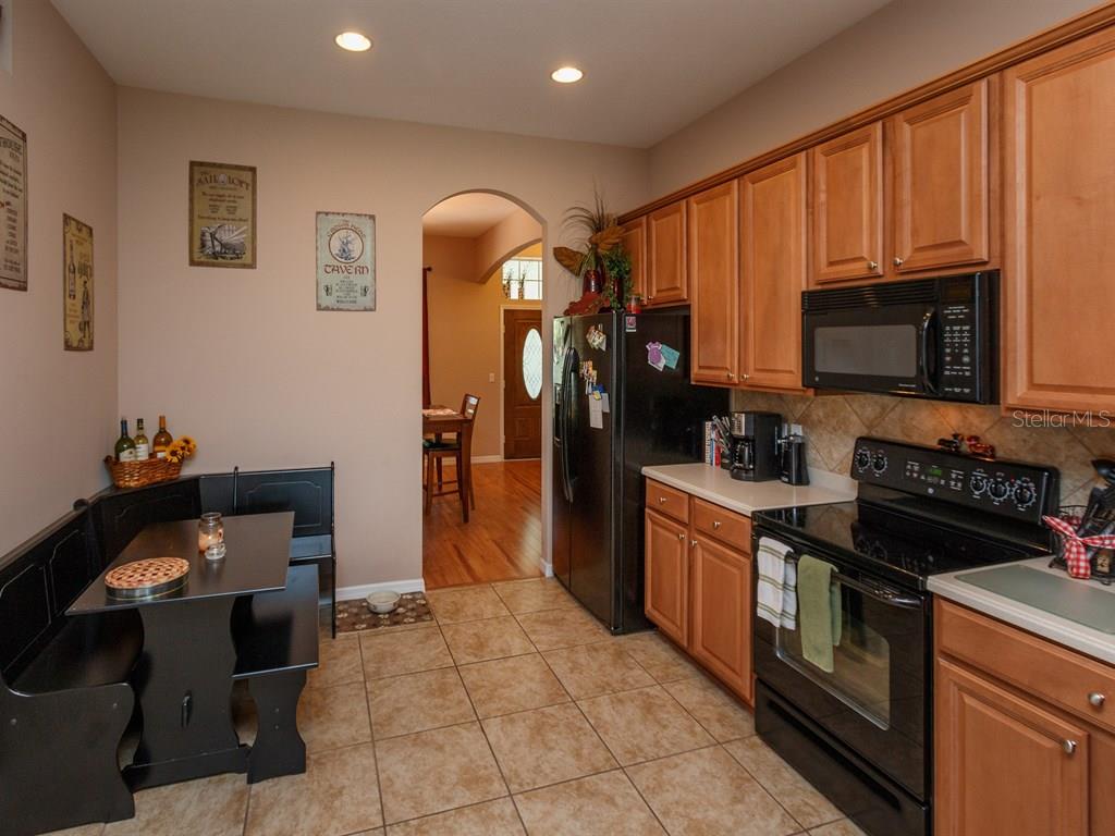 5477 Rishley Run Way Mount Dora, FL 32757 - Photo 7 of 25 a kitchen with a stove cabinets and a sink