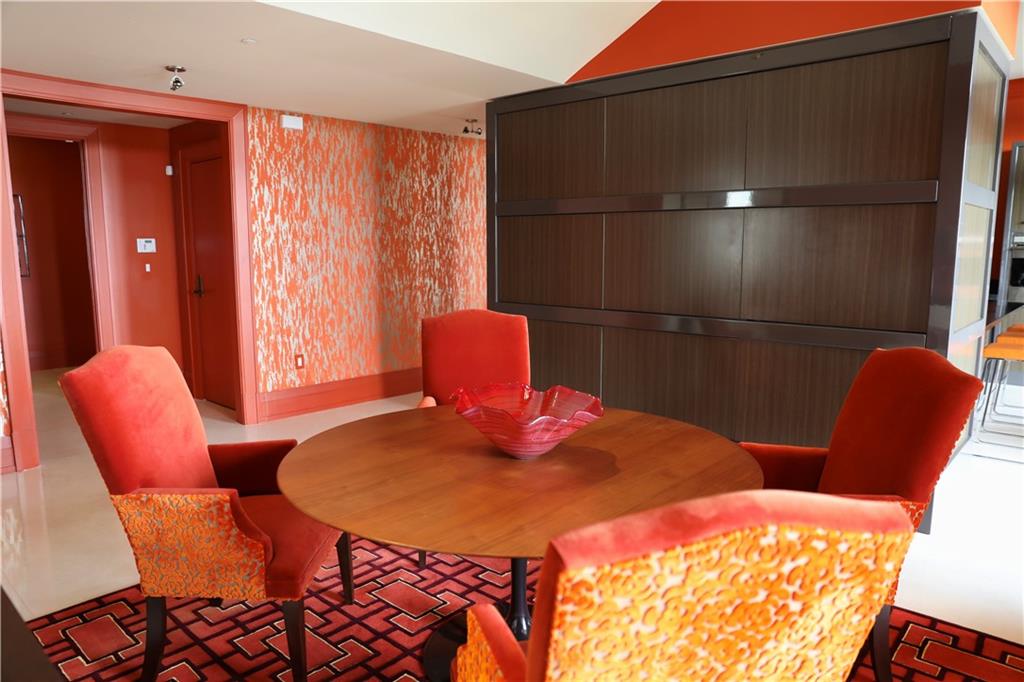 88 West Paces Ferry Road Northwest, Unit 1130 Atlanta, GA 30305 - Photo 18 of 43 a bedroom with a bed and wooden chair