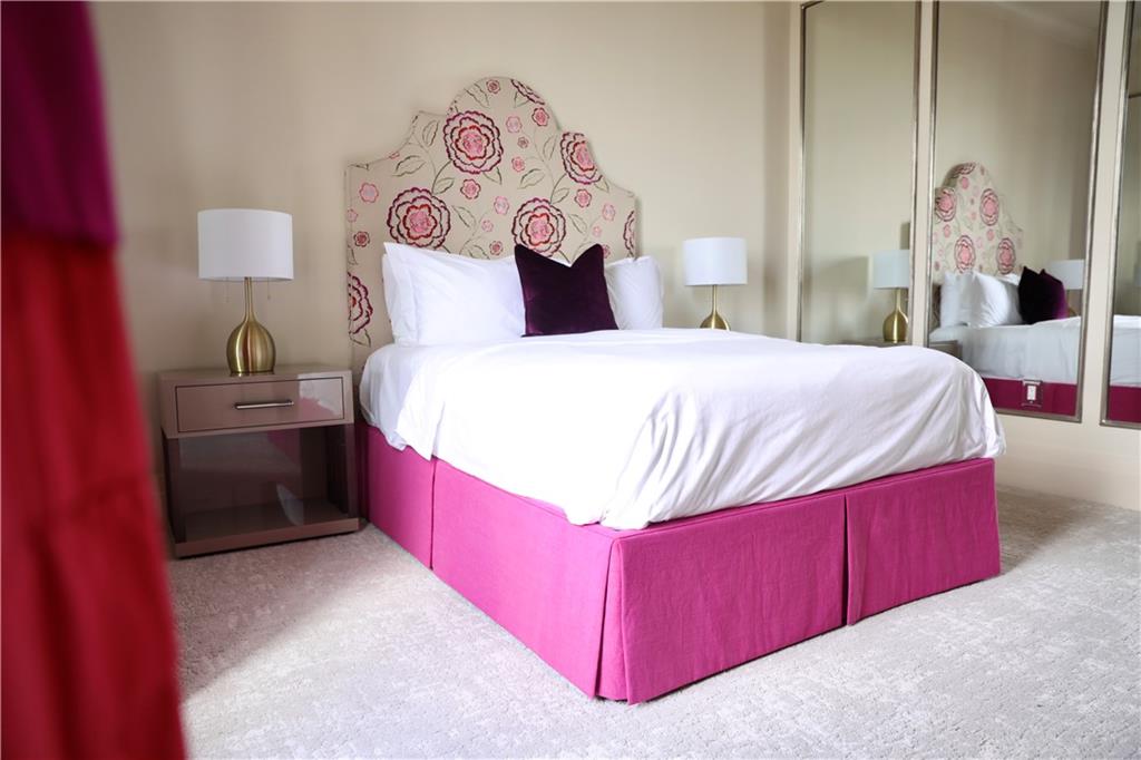 88 West Paces Ferry Road Northwest, Unit 1130 Atlanta, GA 30305 - Photo 22 of 43 a bedroom with a bed and a table with painted walls