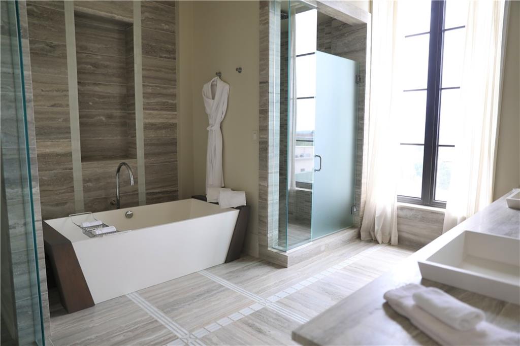 88 West Paces Ferry Road Northwest, Unit 1130 Atlanta, GA 30305 - Photo 30 of 43 a bathroom with a bathtub and a shower