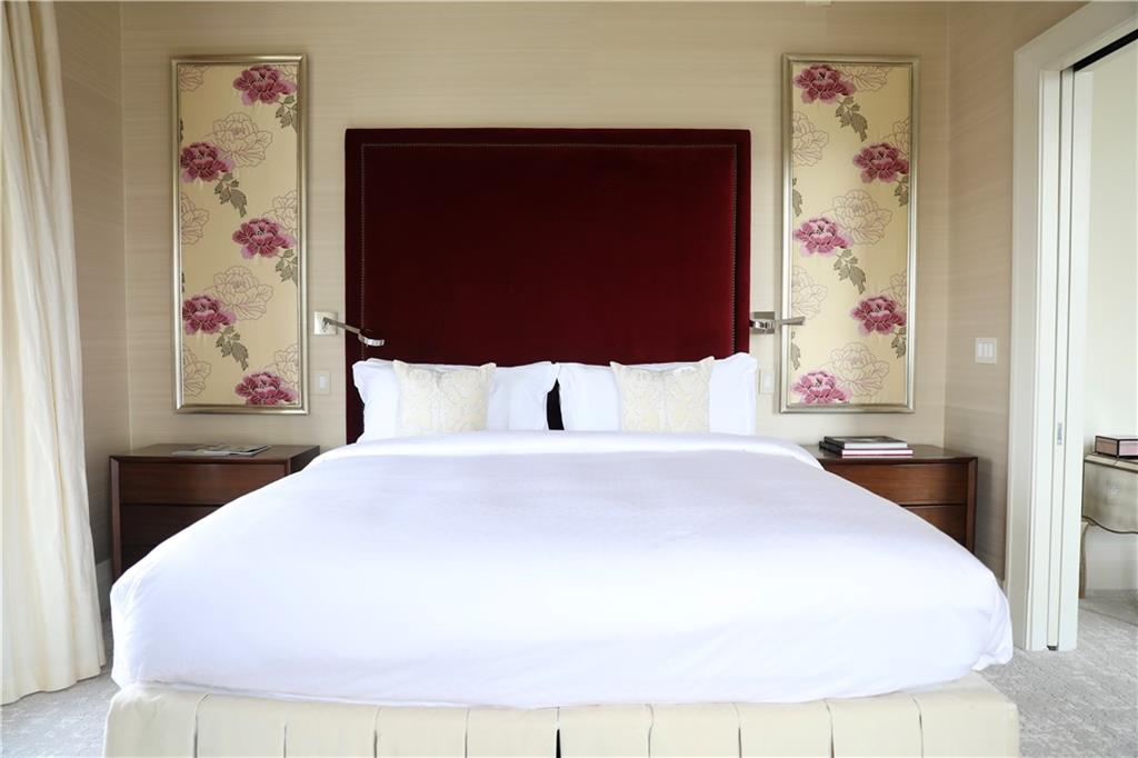 88 West Paces Ferry Road Northwest, Unit 1130 Atlanta, GA 30305 - Photo 31 of 43 a large bed sitting in a bedroom next to a window