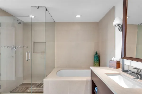 a bedroom with a bed a large window and walk in closet