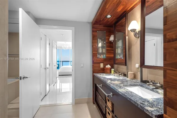 a spacious bedroom with a bed and a flat screen tv