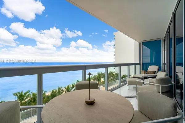 a view of a porch with furniture and a floor to ceiling window