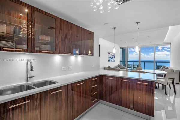 a kitchen with stainless steel appliances granite countertop a sink a stove and a refrigerator