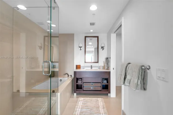 a bathroom with a sink a toilet a tub and shower