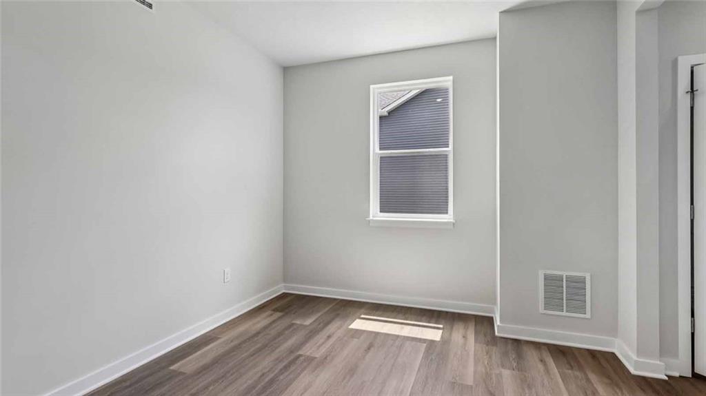 1099 Peachtree Road Carnegie, PA 15106 - Photo 14 of 25 a view of an empty room with wooden floor and a window