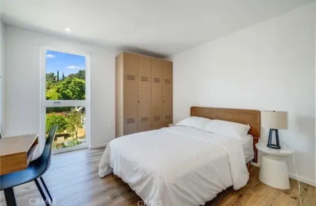 a bedroom with a bed and a window