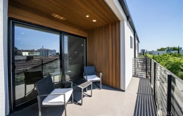 a porch with furniture and next to a window