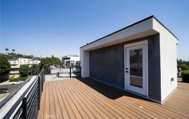 a view of a balcony with chair and wooden floor