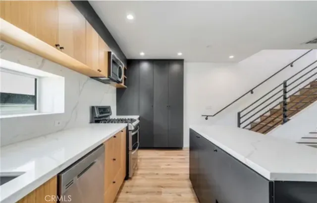 a kitchen that has a sink and a stove in it