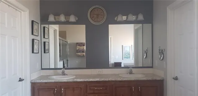 a living room with a flat screen tv and a lamp