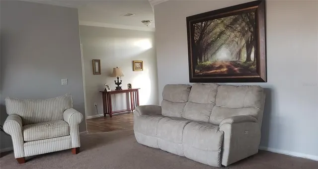 a living room with furniture and a painting