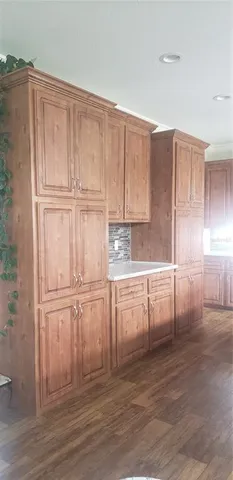 a bedroom with two bed and a lamp on the dresser