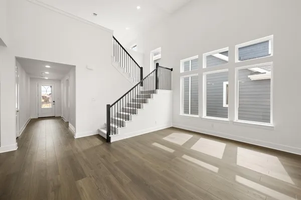 a view of an entryway with wooden floor and stairs