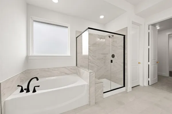 a bathroom with a bathtub and a shower