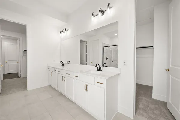 a bathroom with double sink and a mirror