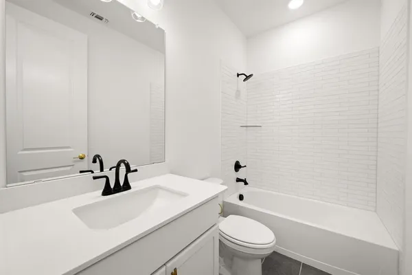 a bathroom with a sink a toilet and a bathtub