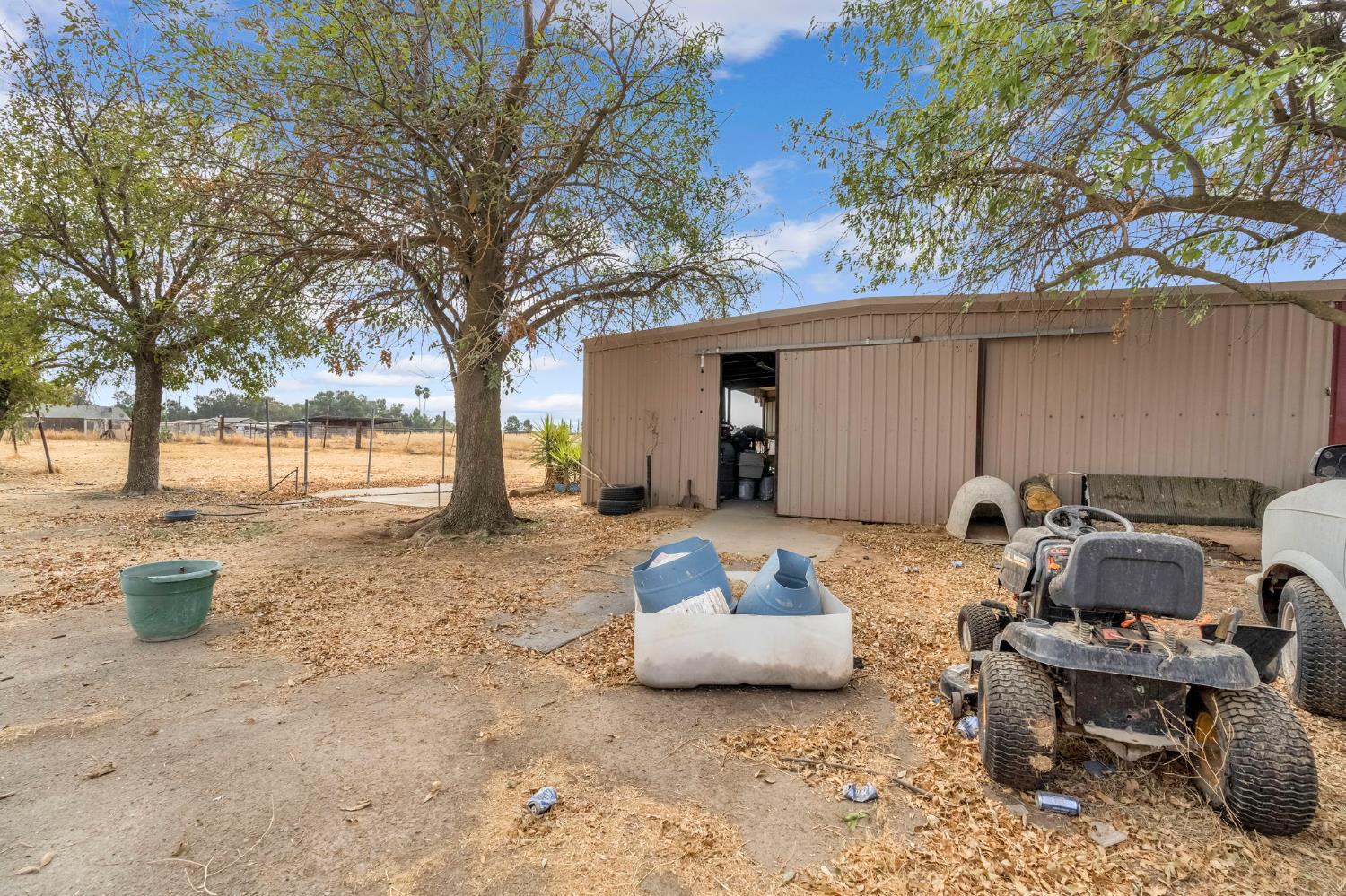 30550 Ave 20 1/2 Madera, CA 93638 - Photo 16 of 24 a view of a patio with couple of chairs and a fire pit