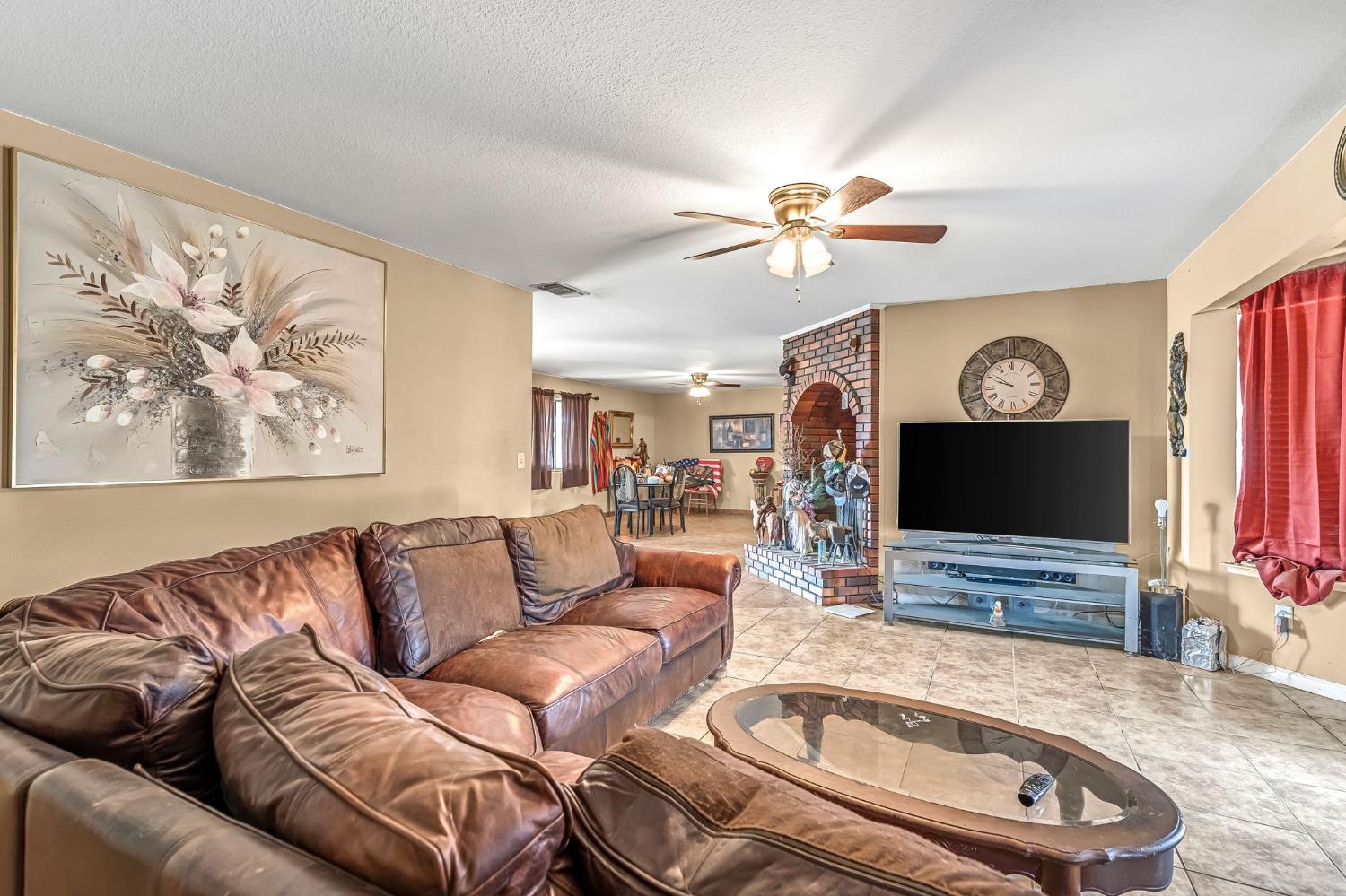 30550 Ave 20 1/2 Madera, CA 93638 - Photo 5 of 24 a living room with furniture a flat screen tv and a fireplace