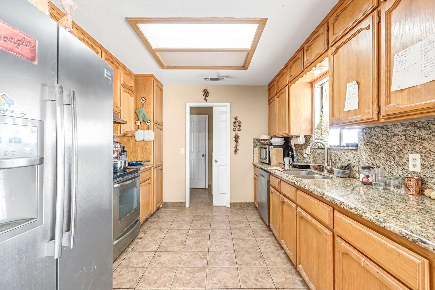 30550 Ave 20 1/2 Madera, CA 93638 - Photo 8 of 24 a kitchen with stainless steel appliances granite countertop a refrigerator and a sink