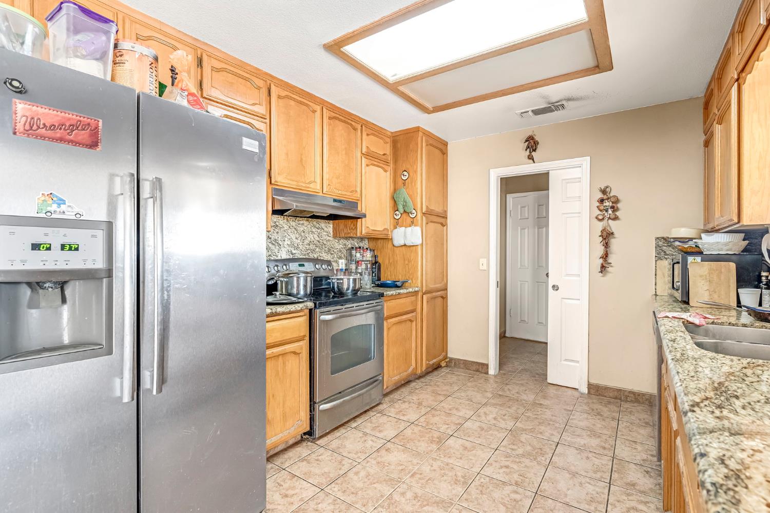30550 Ave 20 1/2 Madera, CA 93638 - Photo 9 of 24 a kitchen with stainless steel appliances granite countertop a refrigerator and a stove