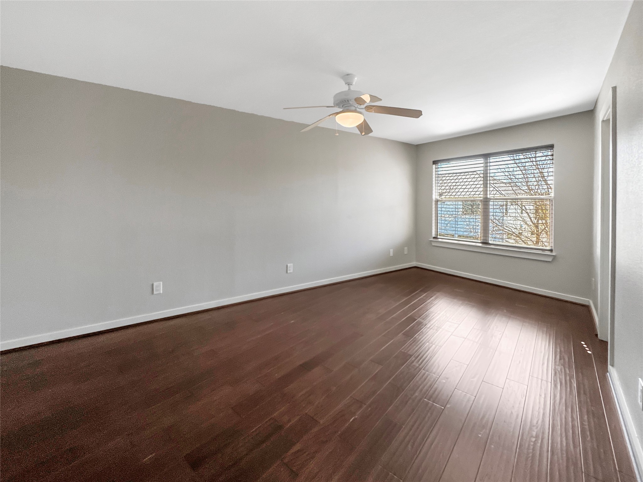 2114 Goodrich Avenue, Unit 4 Austin, TX 78704 - Photo 11 of 24 an empty room with wooden floor and windows